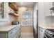 Kitchen with light green cabinets and stainless steel appliances at 1435 Millstream Ln # 202, Dunedin, FL 34698