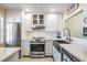 Modern kitchen with stainless steel appliances and white cabinets at 1435 Millstream Ln # 202, Dunedin, FL 34698