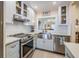 Modern kitchen with stainless steel appliances and white cabinets at 1435 Millstream Ln # 202, Dunedin, FL 34698