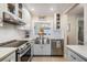 Updated kitchen with stainless steel appliances and white cabinets at 1435 Millstream Ln # 202, Dunedin, FL 34698