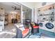 Enclosed laundry with wicker chairs, and view to living area at 1435 Millstream Ln # 202, Dunedin, FL 34698
