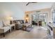 Living room with comfy furniture and access to the balcony at 1435 Millstream Ln # 202, Dunedin, FL 34698