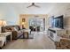 Living room with comfy furniture and access to the balcony at 1435 Millstream Ln # 202, Dunedin, FL 34698