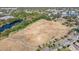 Open green space with a walking path and nearby tennis court at 1435 Millstream Ln # 202, Dunedin, FL 34698