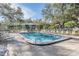 Community pool with plenty of lounge chairs at 1435 Millstream Ln # 202, Dunedin, FL 34698