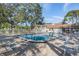 Inviting community pool area with surrounding lounge chairs at 1435 Millstream Ln # 202, Dunedin, FL 34698