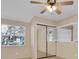 Bedroom with mirrored closet doors and ceiling fan at 1510 Mahogany Ln # 606, Palm Harbor, FL 34683