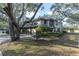 Two-story townhouse with green metal roof and lush landscaping at 1510 Mahogany Ln # 606, Palm Harbor, FL 34683