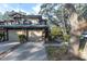 Two-car garage, front yard landscaping, and brick facade at 1510 Mahogany Ln # 606, Palm Harbor, FL 34683