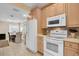 Modern kitchen with white appliances and wood cabinets at 1510 Mahogany Ln # 606, Palm Harbor, FL 34683