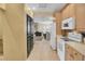 Kitchen with white appliances and view into dining area at 1510 Mahogany Ln # 606, Palm Harbor, FL 34683