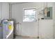 Utility room with water heater, electrical panel, and window at 4561 Shore Acres Ne Blvd, St Petersburg, FL 33703