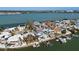 Aerial view showing waterfront homes, private docks, and boats along the scenic coastline at 807 Bay Point Dr, Madeira Beach, FL 33708