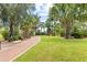 Brick pathway winds through lush tropical landscaping at 1120 North Shore Ne Dr # 1004, St Petersburg, FL 33701