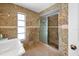 Bathroom with granite tile, shower, and single sink vanity at 1713 Grand Central Dr, Tarpon Springs, FL 34689