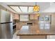 Kitchen with granite countertops and light wood cabinets at 1713 Grand Central Dr, Tarpon Springs, FL 34689