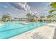 Community lap pool and leisure pool with lounge chairs at 31451 Moniker Mast Ln, San Antonio, FL 33576