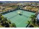 Two well-maintained tennis courts with shaded seating area at 31451 Moniker Mast Ln, San Antonio, FL 33576