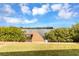 Beautiful view of the dock with a grassy yard, lush greenery, and stunning water views at 945 Bayshore Dr, Tarpon Springs, FL 34689