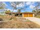House exterior with double garage and mature landscaping at 945 Bayshore Dr, Tarpon Springs, FL 34689