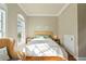 Bright bedroom with a queen bed, wicker furniture, and access to a small attic at 140 Brightwater Dr # 6, Clearwater Beach, FL 33767