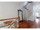 Bright hallway with a spiral staircase, hardwood floors, and large mirror at 140 Brightwater Dr # 6, Clearwater Beach, FL 33767