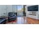 Relaxing living room with hardwood floors and access to a balcony overlooking the water at 140 Brightwater Dr # 6, Clearwater Beach, FL 33767
