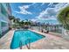 Community pool with waterfront views and lounge chairs at 140 Brightwater Dr # 6, Clearwater Beach, FL 33767