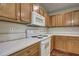 Clean kitchen featuring white appliances, wood cabinets and ample counter space at 20538 Homossasa Ct, Land O Lakes, FL 34637