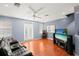 Game room with leather couch, large TV, and access to balcony at 3010 Bayshore Pointe Dr, Tampa, FL 33611