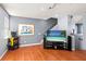 Game room features hardwood floors, large TV, and arcade game at 3010 Bayshore Pointe Dr, Tampa, FL 33611