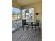 Screened balcony overlooking the water with seating for two at 844 Callista Cay Loop, Tarpon Springs, FL 34689