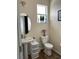 Clean bathroom with pedestal sink, toilet and window at 844 Callista Cay Loop, Tarpon Springs, FL 34689