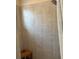 Clean bathroom with a shower, tiled walls, and a wooden seat at 844 Callista Cay Loop, Tarpon Springs, FL 34689