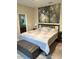 Main bedroom with king-size bed and large art piece at 844 Callista Cay Loop, Tarpon Springs, FL 34689