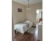 Small bedroom with twin bed and wood floors at 844 Callista Cay Loop, Tarpon Springs, FL 34689