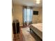 Bright bedroom with wood floors, window coverings, and a TV at 844 Callista Cay Loop, Tarpon Springs, FL 34689