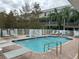 Refreshing community pool with lounge chairs and brick deck at 844 Callista Cay Loop, Tarpon Springs, FL 34689