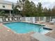 Inviting community pool area with ample lounge chairs at 844 Callista Cay Loop, Tarpon Springs, FL 34689