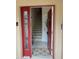 Front entry with red door and staircase leading upstairs at 844 Callista Cay Loop, Tarpon Springs, FL 34689