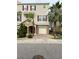 Two-story townhome with red door, attached garage, and landscaping at 844 Callista Cay Loop, Tarpon Springs, FL 34689