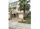 Two story townhome with attached garage and palm trees at 844 Callista Cay Loop, Tarpon Springs, FL 34689