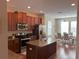 Modern kitchen with stainless steel appliances and island at 844 Callista Cay Loop, Tarpon Springs, FL 34689