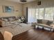 Living room featuring hardwood floors, comfy seating, and a large window at 844 Callista Cay Loop, Tarpon Springs, FL 34689
