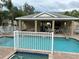 Community pool and spa with covered seating area at 844 Callista Cay Loop, Tarpon Springs, FL 34689