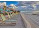 Beachfront property with lounge chairs and pathway at 4621 Gulf Of Mexico Dr # D10, Longboat Key, FL 34228