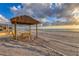 Beachfront picnic table under thatched roof gazebo at 4621 Gulf Of Mexico Dr # D10, Longboat Key, FL 34228