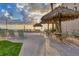 Beachfront patio area with tiki huts, lounge chairs, and tables for relaxing at 4621 Gulf Of Mexico Dr # D10, Longboat Key, FL 34228
