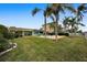 Landscaped backyard with pool, offering outdoor oasis at 11800 7Th E St, Treasure Island, FL 33706