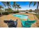 Relaxing pool with patio chairs, overlooking the water at 11800 7Th E St, Treasure Island, FL 33706